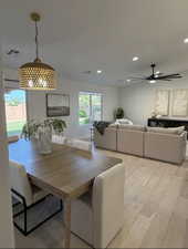 Open-concept living area featuring wood-finish flooring, recessed lighting, and a modern ceiling fan