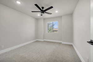 Empty room with light carpet, ceiling fan, and recessed lighting