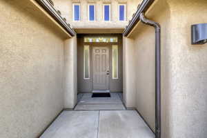 Doorway to property with stucco siding