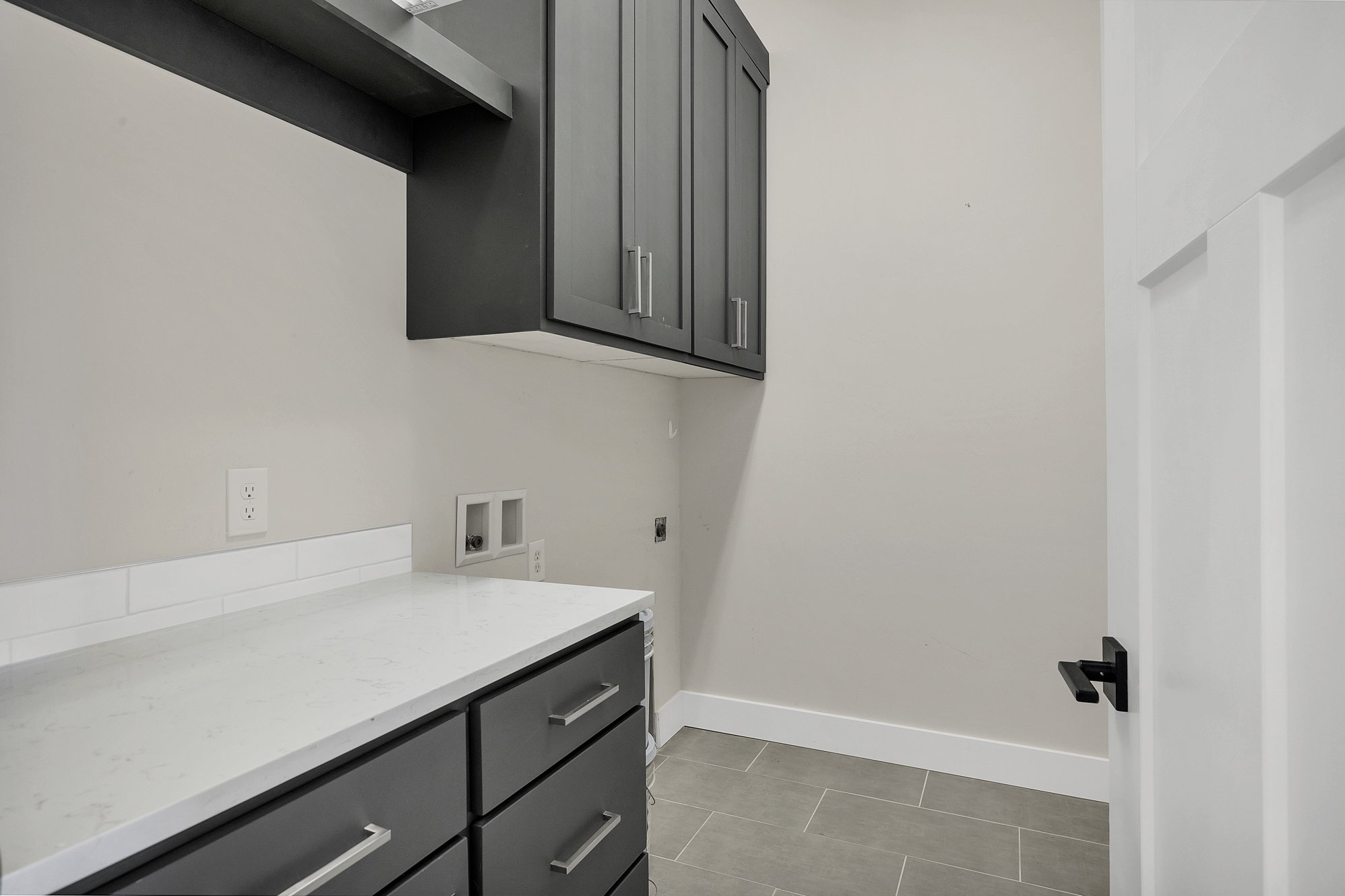 Laundry room with hookup for a washing machine, cabinet space, and electric dryer hookup