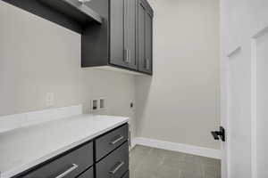 Laundry room with hookup for a washing machine, cabinet space, and electric dryer hookup