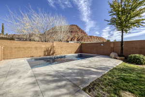 View of swimming pool with a fenced backyard and a mountain view