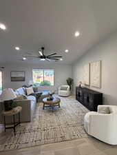 Spacious living area featuring light-toned flooring, recessed lighting, and a modern ceiling fan