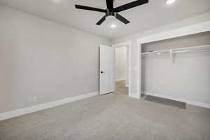 Unfurnished bedroom featuring light colored carpet, ceiling fan, recessed lighting, and a closet