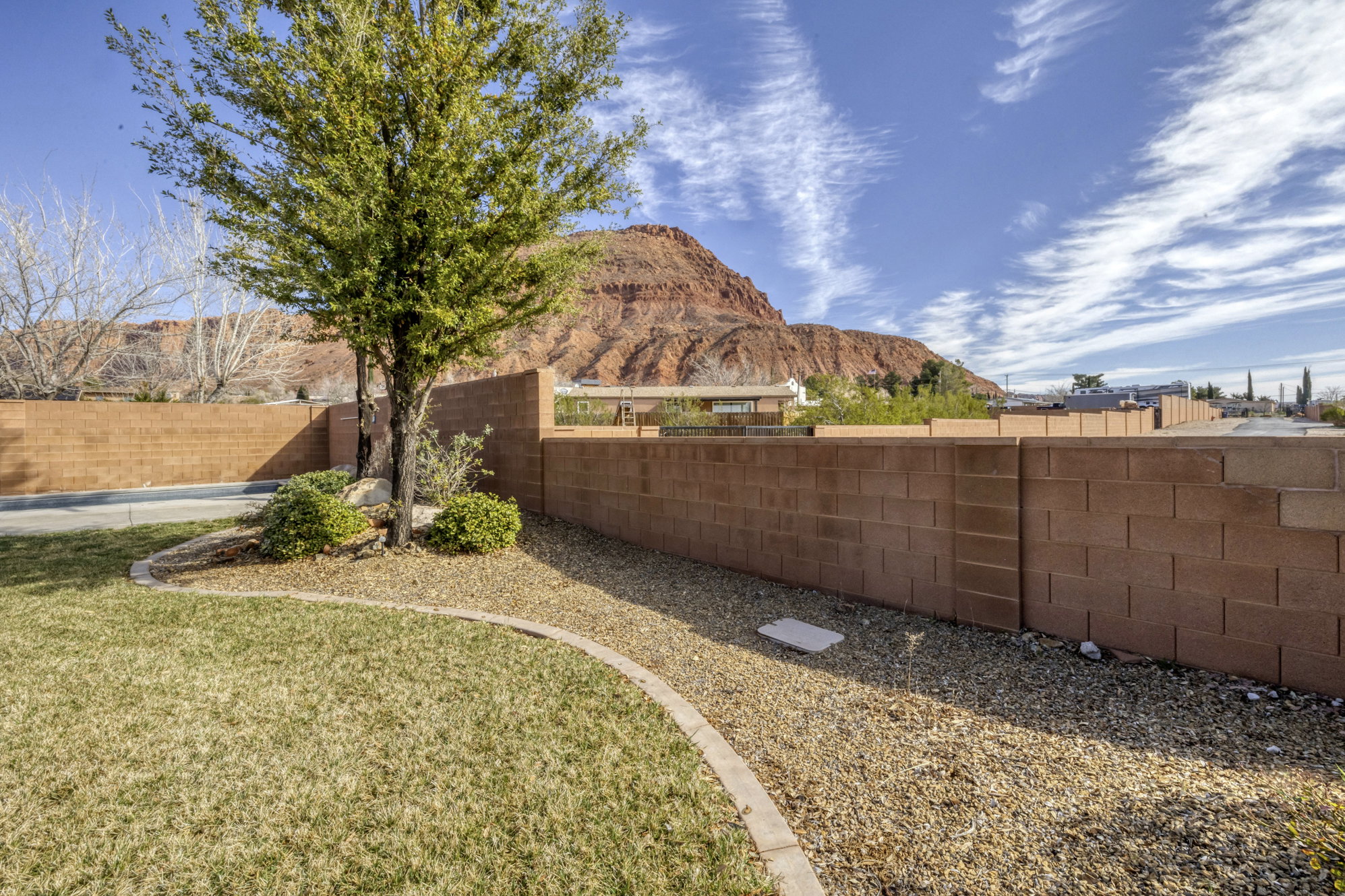 Fenced backyard featuring a mountain view