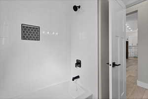 Full bathroom featuring shower / bathtub combination, light wood-style floors, and recessed lighting