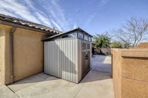 View of shed with a fenced backyard
