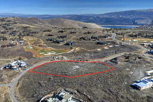 Aerial view of property's location featuring a water and mountain view and property parcel outlined