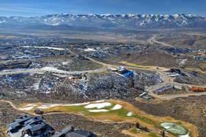 Aerial view of property and surrounding area with a mountain backdrop