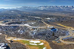 Aerial view of property and surrounding area with a mountainous background
