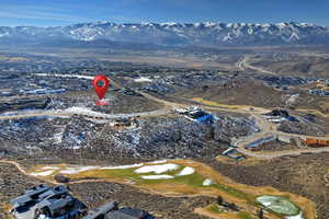 Aerial view of property's location featuring a mountain backdrop