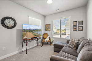 Sitting room with light carpet and baseboards
