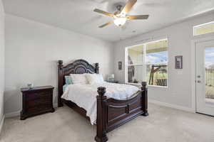 Bedroom with access to outside, light carpet, a ceiling fan, and a textured ceiling