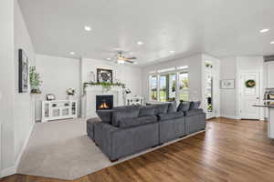 Living area featuring recessed lighting, a  fireplace, wood finished floors, a ceiling fan, and a textured ceiling