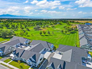 Aerial perspective of suburban area with a local golf course and a mountainous background