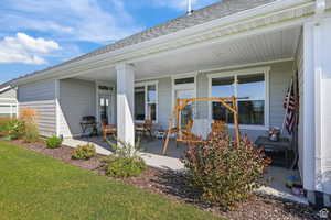 Back of property featuring a shingled roof and a yard
