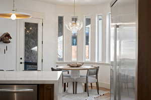Dining space featuring light wood-type flooring and hanging lights