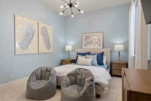 Bedroom featuring a chandelier and light carpet
