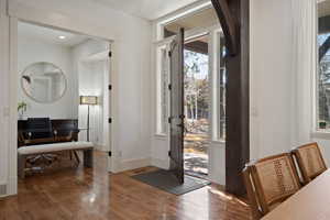 Entrance foyer with wood finished floors and baseboards