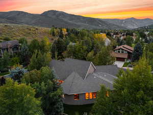 Aerial view at dusk of a mountain view and view of wooded area