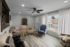 Living room featuring recessed lighting, light wood-type flooring, and a ceiling fan