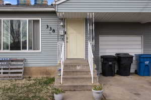 Doorway to property featuring a garage
