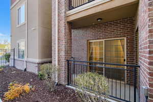 Doorway to property featuring brick siding