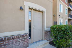 Doorway to property with stucco siding