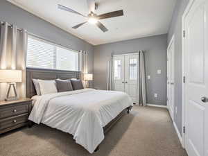 Bedroom featuring carpet flooring, a ceiling fan, multiple windows, and a closet