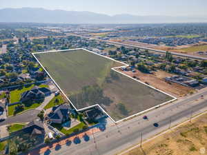 Aerial view of property's location featuring property parcel outlined and nearby suburban area