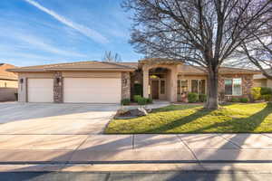 View of front of house featuring stone siding, an attached garage, stucco siding, concrete driveway, and a front yard