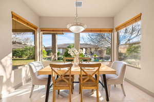 Sunroom featuring baseboards and tile patterned flooring