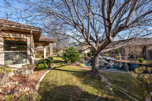 View of green lawn featuring a water view