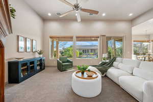 Living area with carpet floors, a ceiling fan, recessed lighting, and plenty of natural light