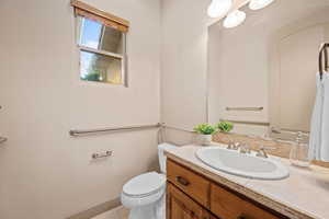 Bathroom featuring vanity and backsplash