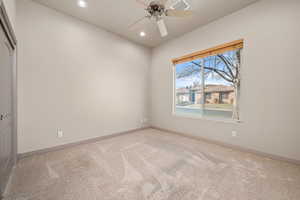 Empty room with light colored carpet, a ceiling fan, and recessed lighting