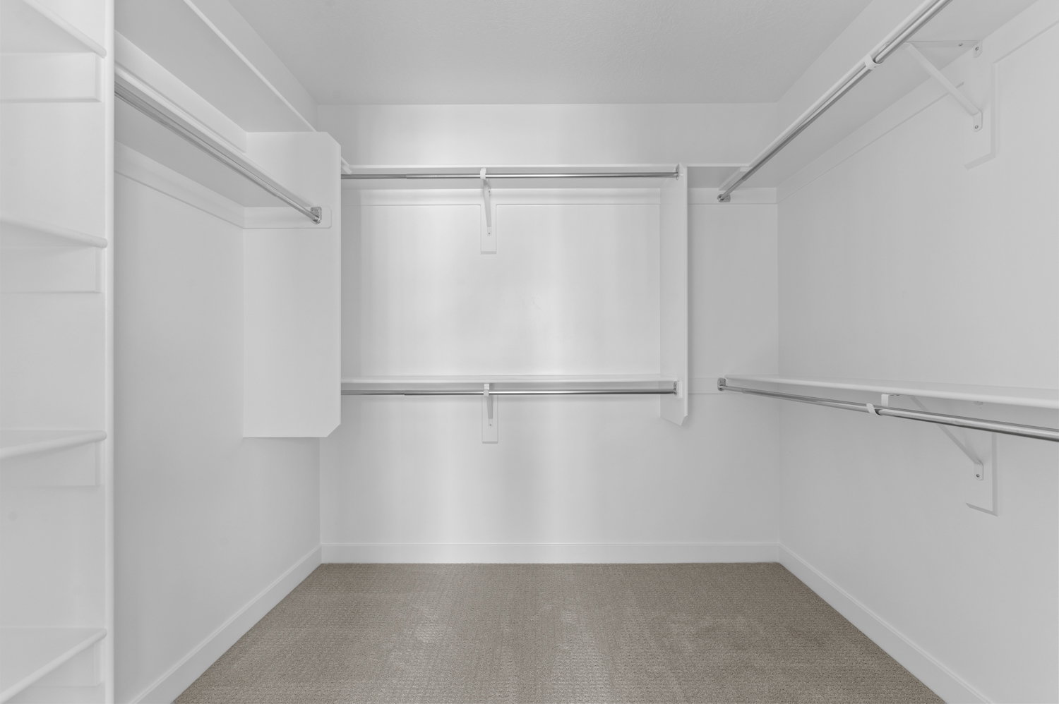 Walk in closet with light colored carpet