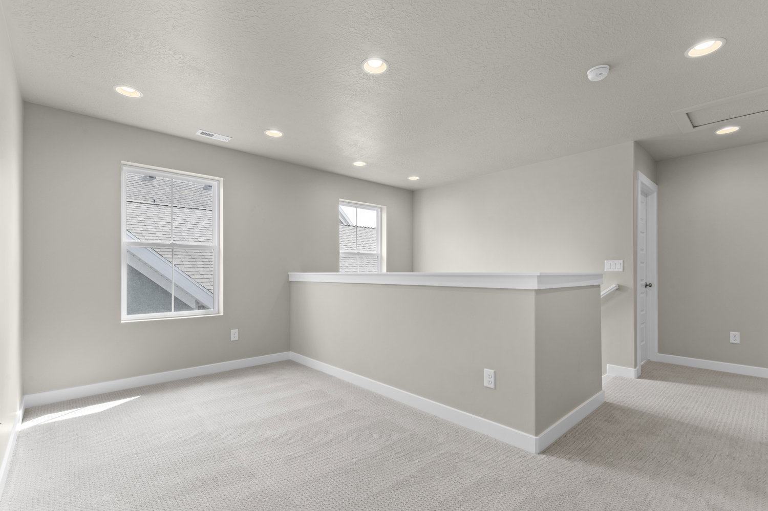 Empty room with recessed lighting, light carpet, and a textured ceiling