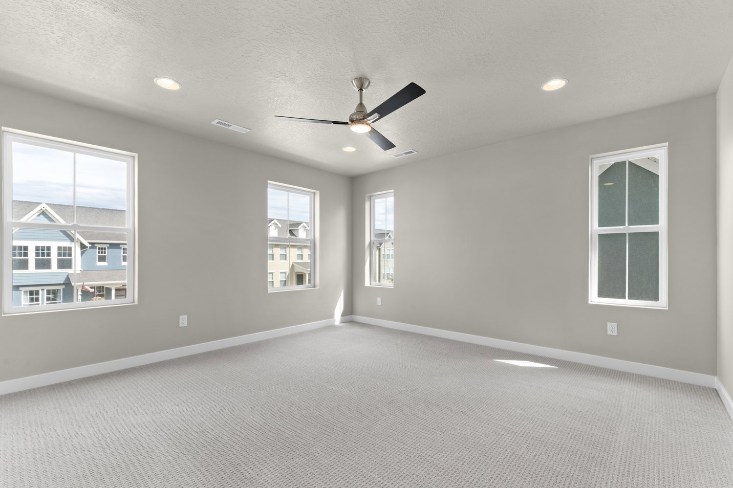 Unfurnished room featuring light carpet, ceiling fan, recessed lighting, and a textured ceiling