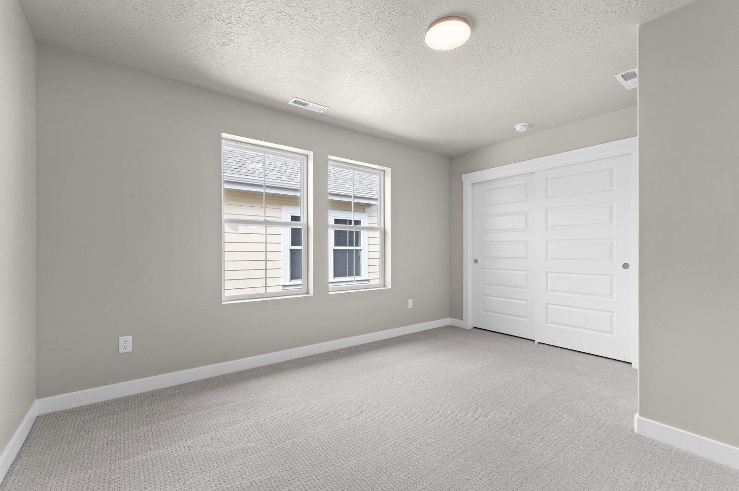 Unfurnished bedroom featuring light carpet, a closet, and a textured ceiling