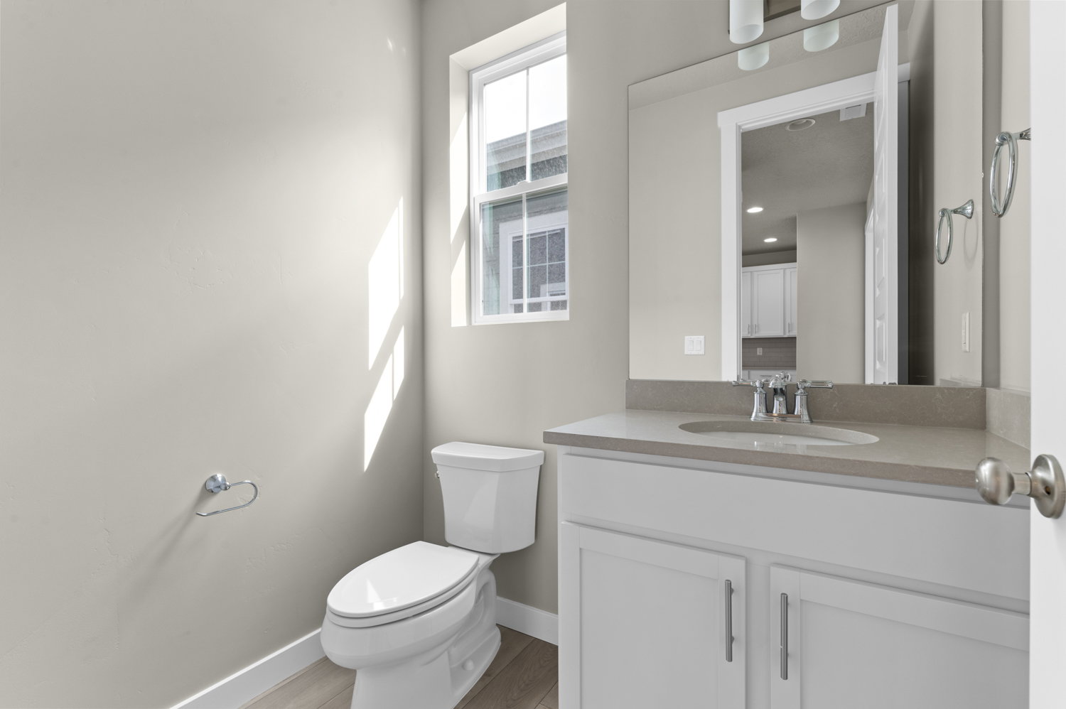 Half bath featuring vanity and light wood-type flooring