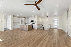 Unfurnished living room with ceiling fan, light wood-style flooring, and recessed lighting