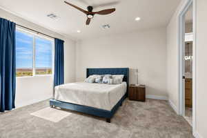 Bedroom with light colored carpet, a ceiling fan, recessed lighting, and ensuite bathroom