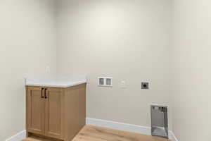 Laundry area featuring washer hookup, light wood-type flooring, and electric dryer hookup
