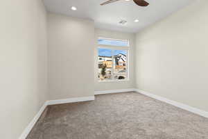 Unfurnished room featuring carpet, recessed lighting, and a ceiling fan