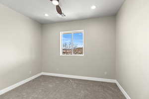 Carpeted spare room with ceiling fan and recessed lighting