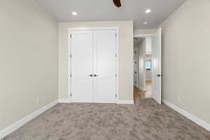 Unfurnished bedroom with light carpet, a closet, recessed lighting, and ceiling fan