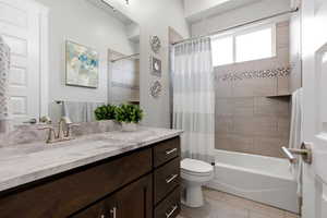 Bathroom featuring vanity and shower / bath combination with curtain
