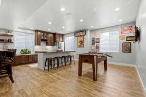 Rec room with light wood-style floors and recessed lighting