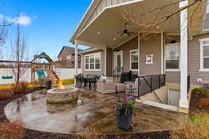 View of patio / terrace with outdoor dining area, a playground, ceiling fan, and an outdoor fire pit